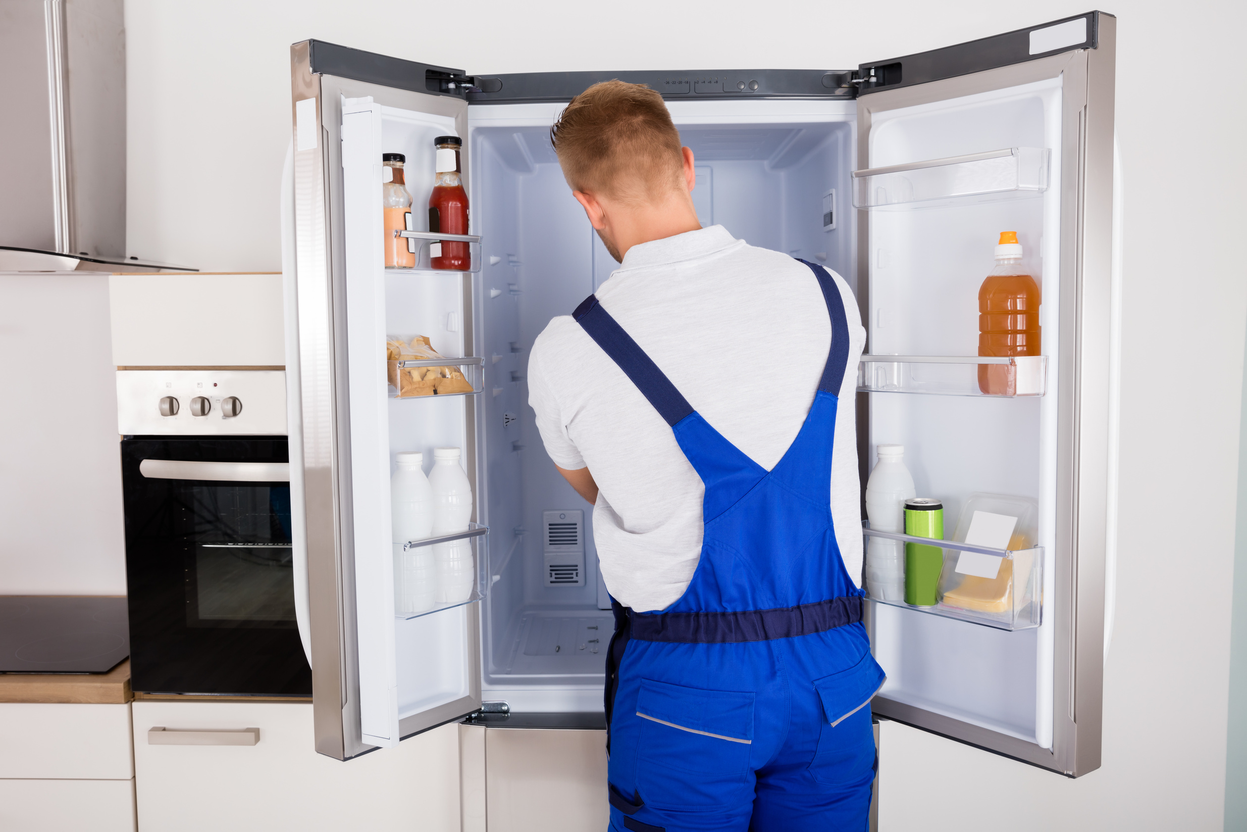 Repairman Fixing Refrigerator